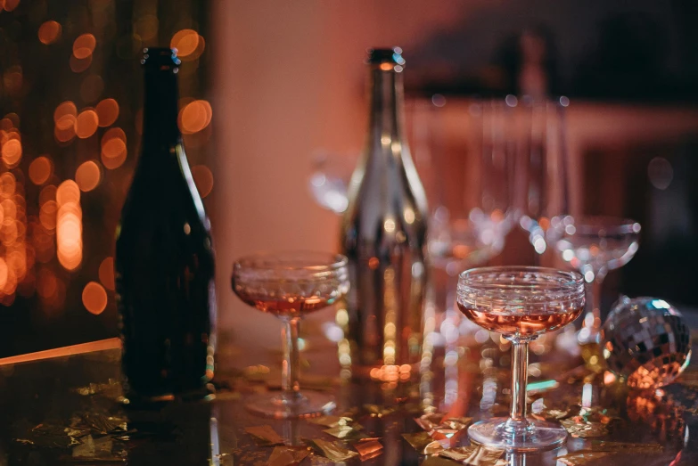 a group of wine glasses sitting on top of a table, by Lee Loughridge, pexels contest winner, renaissance, lots of bubbles, rose gold, cocktail in an engraved glass, retro stylised