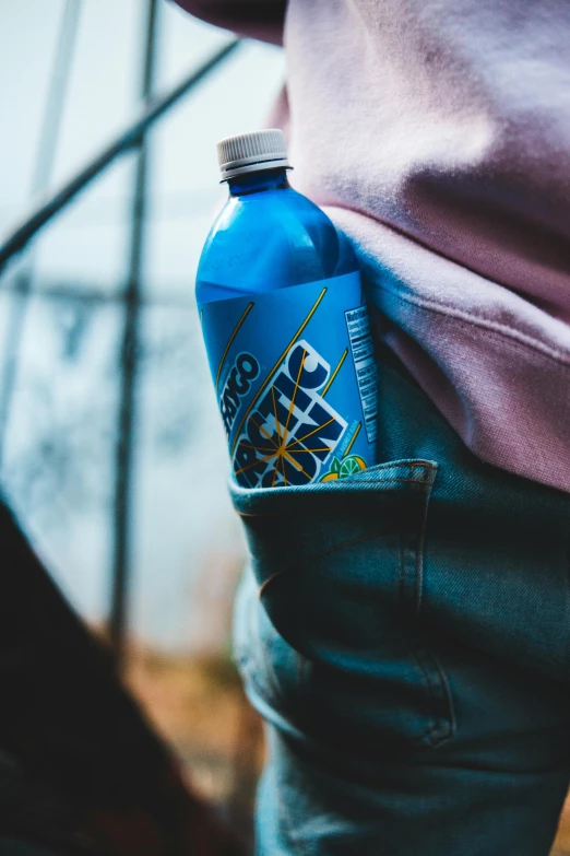 a person holding a water bottle in their pocket, graffiti, electric blue, cold brew coffee ), hero shot, zoomed in