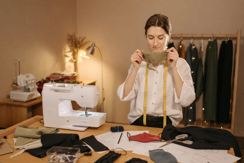 a woman standing in front of a sewing machine