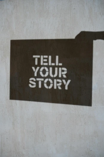 a sign that says tell your story on a wall, by Tony Tuckson, cel shadow, promo image, pictogram, 9/11