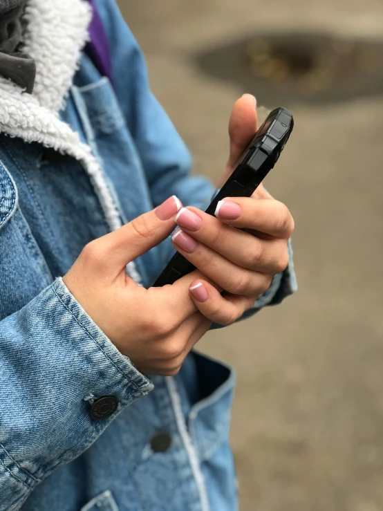 a close up of a person holding a cell phone, by Niko Henrichon, happening, non-binary, square, low quality photo, unclipped fingernails