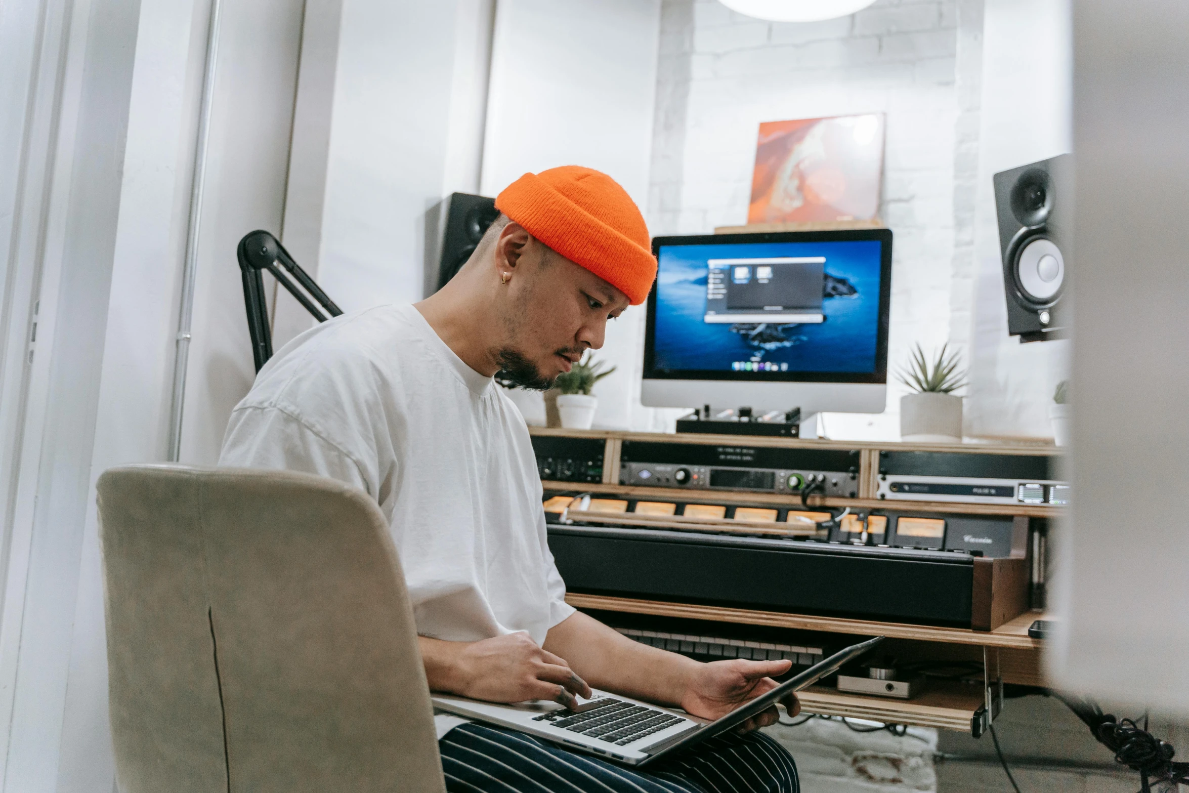 a man sitting in front of a laptop computer, an album cover, pexels contest winner, doug chiang, in a studio, working, youtube thumbnail