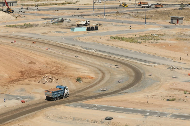 a large truck driving down a dirt road, a portrait, flickr, jeddah city street, under construction, 15081959 21121991 01012000 4k, birdseye view