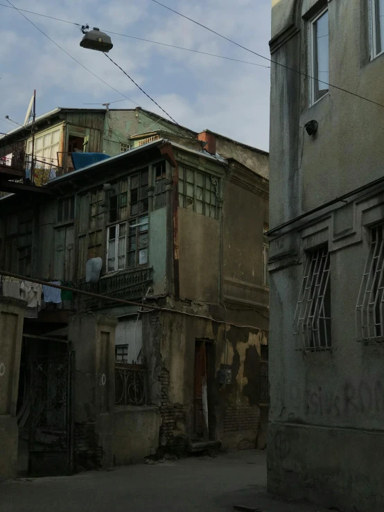 a couple of buildings that are next to each other, dirty and old, ayanamikodon and irakli nadar, exterior photo