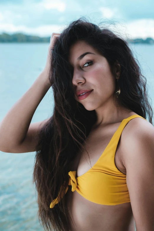 a woman in a yellow bikini posing in front of a body of water, pexels contest winner, portrait of zendaya, headshot profile picture, alanis guillen, lake view