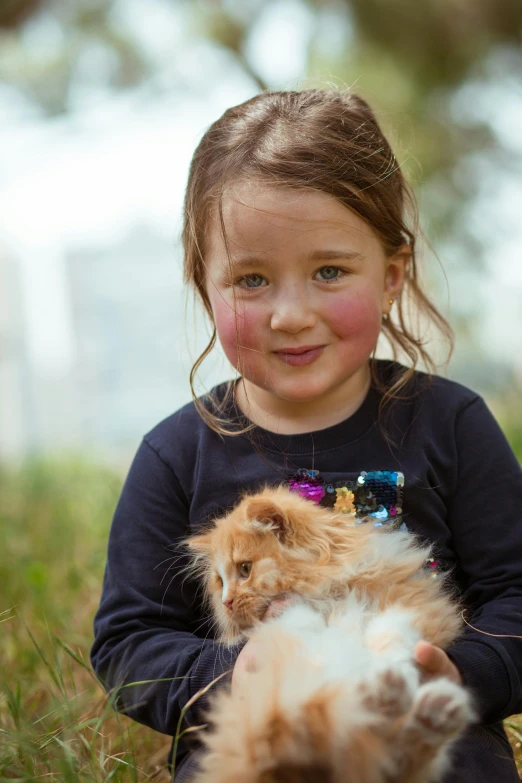 a little girl sitting in the grass with a cat, a portrait, shutterstock contest winner, straya, portrait close up, at the park, urban surroundings