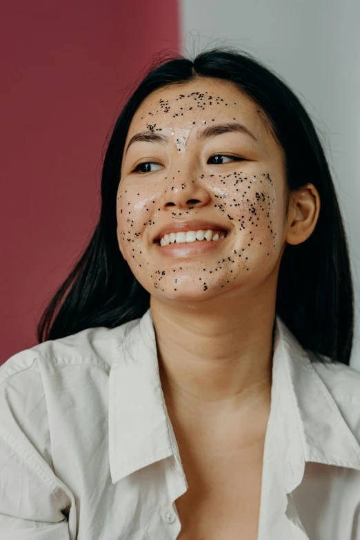 a woman with black spots on her face, trending on pexels, mingei, with a happy expression, product shot, asian, covered in