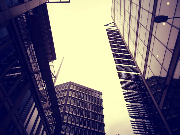 a couple of tall buildings next to each other, unsplash, modernism, sepia photography, worm\'s eye view, london architecture, coloured