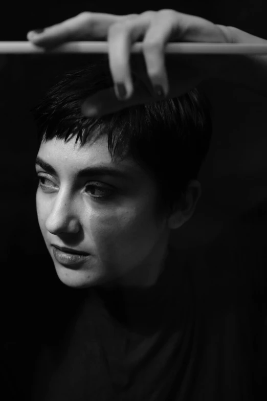 a black and white photo of a young man, by irakli nadar, woman with black hair, pixie cut, maia sandu hyperrealistic, queer woman