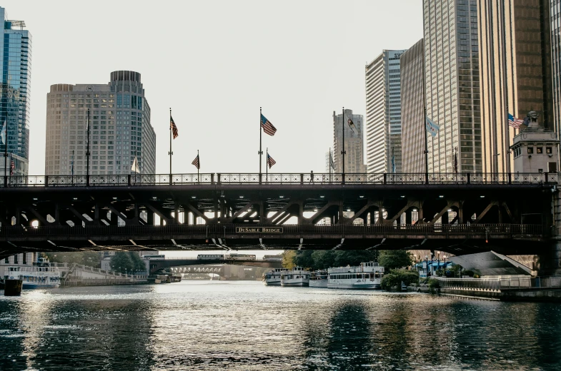 a bridge over a body of water surrounded by tall buildings, a photo, by Robbie Trevino, from wheaton illinois, ignant, a quaint, banner