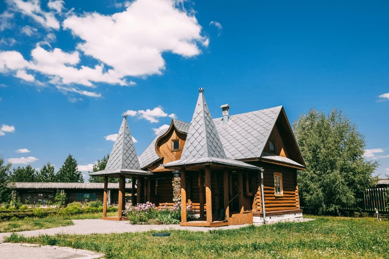 a wooden house sitting on top of a lush green field, unsplash, art nouveau, russian architecture, exterior photo, glamping, 2 0 0 0's photo