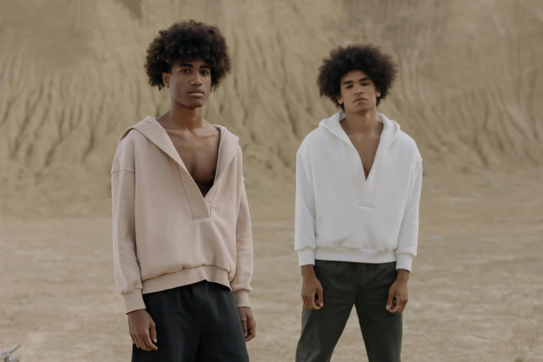 a couple of young men standing next to each other, unsplash, renaissance, beige hoodie, imaan hammam, smooth body features, cotton