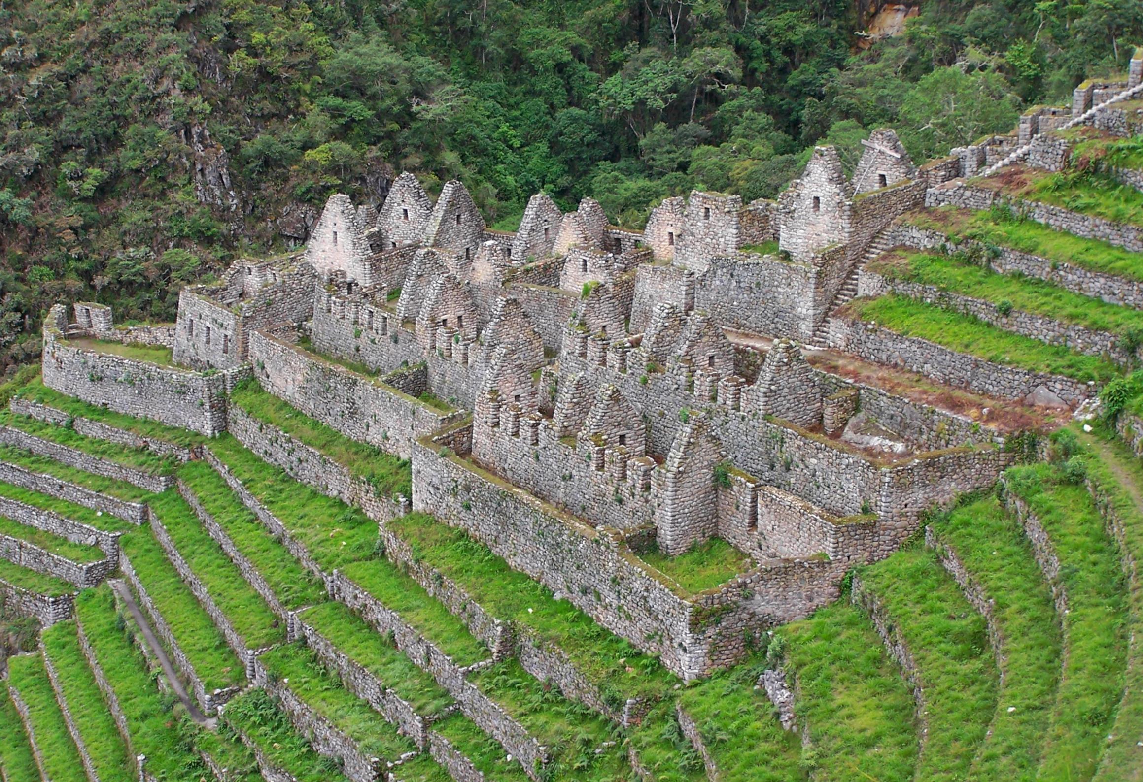 a large stone structure sitting on top of a lush green hillside, a mosaic, inca themed smooth, gray, thumbnail, birdeye