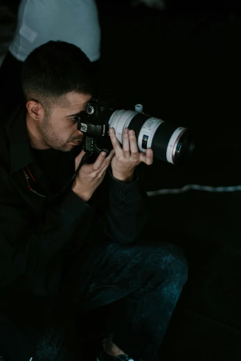 a man taking a picture with a camera, by Robbie Trevino, low light cinematic, professional photo-n 3, high quality image, photography]