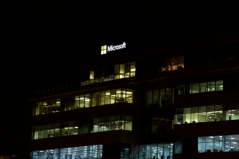 a large office building lit up at night, by Meredith Dillman, pexels, microsoft windows logo, square, low iso, high picture quality