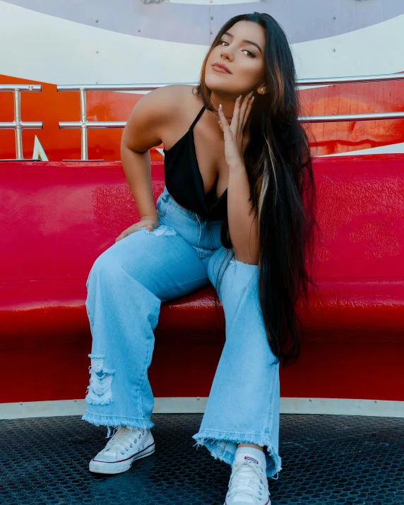 a woman sitting on top of a red bench, by Robbie Trevino, wearing jeans, profile image, pokimane, profile photo