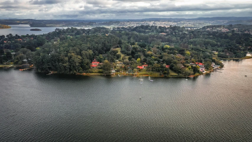 an aerial view of a small island in the middle of a lake, by Peter Churcher, pexels contest winner, hurufiyya, sao paulo, lake house, as seen from the canopy, panorama view