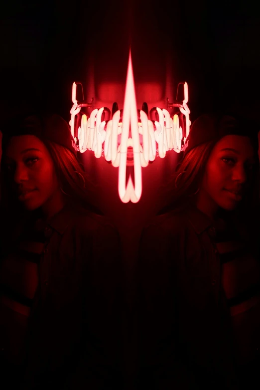 a group of people standing in front of a red light, an album cover, inspired by Cerith Wyn Evans, unsplash, hurufiyya, devil wings, mirrored, symmetry!! portrait of akuma, volumetric lighting. red