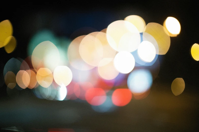 a blurry photo of a city street at night, by Tom Bonson, unsplash, visual art, overcast bokeh - c 5, multi colored, headlights, close - up photograph