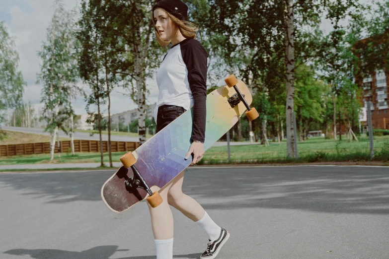 a woman walking down a street holding a skateboard, by Emma Andijewska, unsplash contest winner, iridescent visor, standing on a skateboard, plain background, van