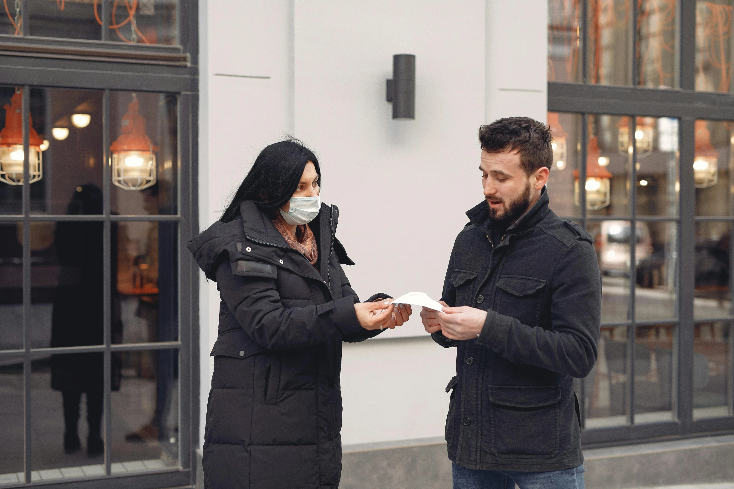 a man and a woman standing in front of a building, at checkout, coronavirus, square, kacper niepokolczycki