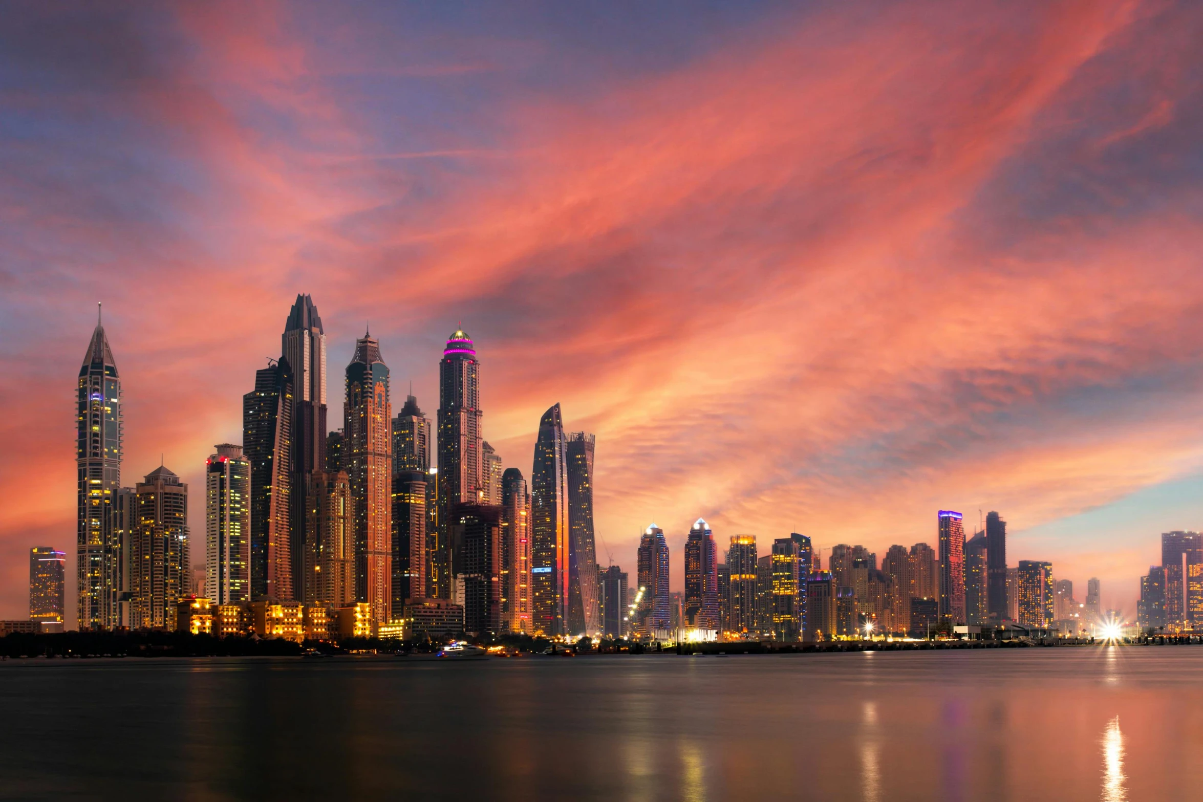 a large body of water with a city in the background, an album cover, pexels contest winner, renaissance, dubai, vibrant sunset, panoramic, stacked image