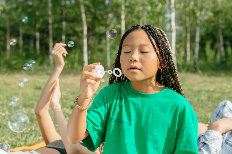 a young girl blowing bubbles while sitting on a blanket, by Adam Marczyński, pexels contest winner, summer camp, willow smith young, avatar image, eero aarnio