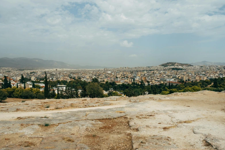 a view of a city from the top of a hill, pexels contest winner, neoclassicism, greek fabric, faded and dusty, 90s photo, ground - level medium shot