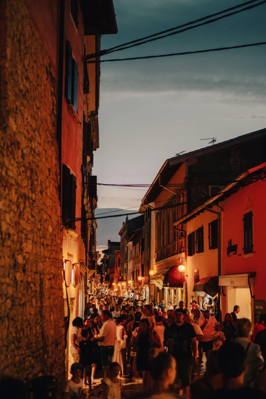 a crowd of people walking down a street at night, renaissance, villages, taken at golden hour, bizzaro, high quality image