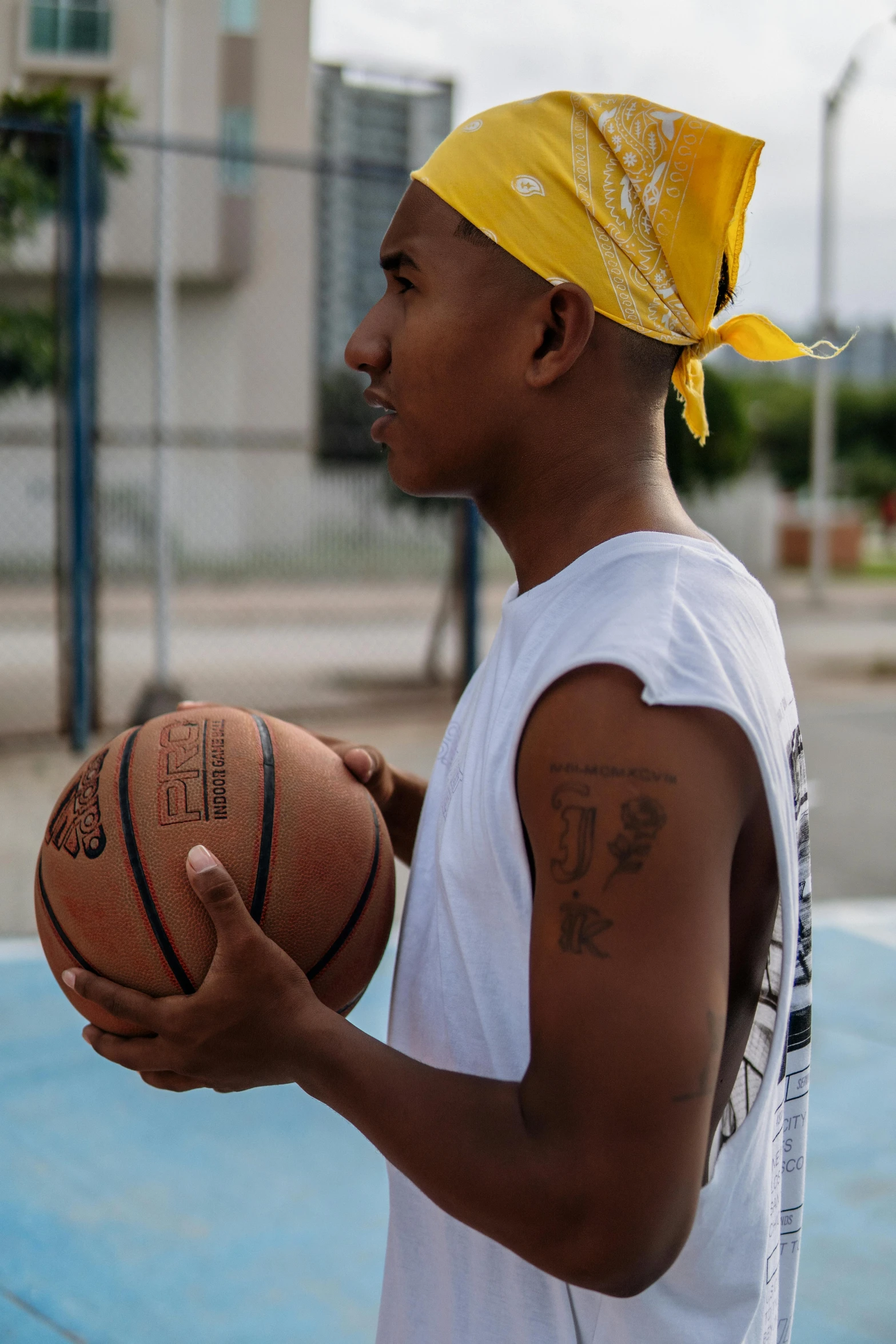 a man standing on a basketball court holding a basketball, a tattoo, trending on dribble, colombian, profile image