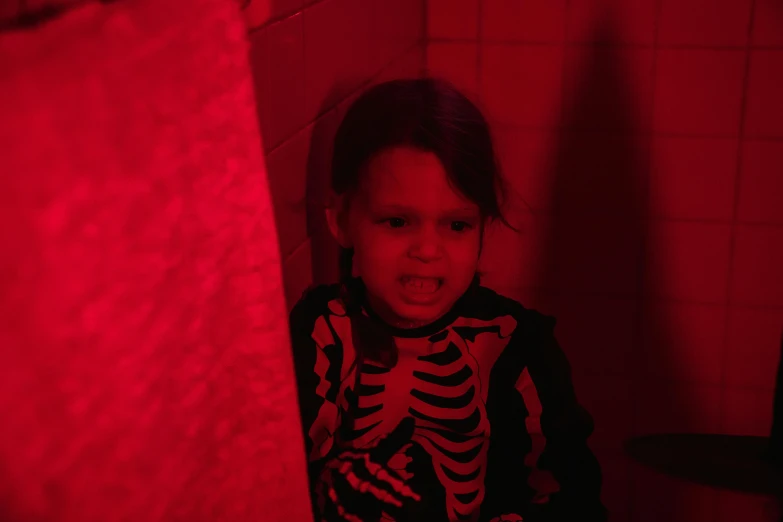 a little girl in a dark room with a red light, in a bathroom, in a halloween style, lucas graziano, black on red