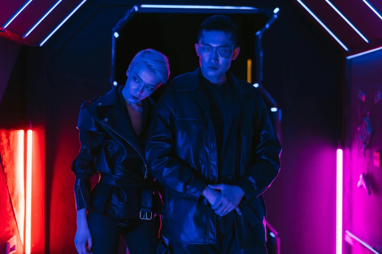 two people standing next to each other in neon lights, cyberpunk art, inspired by Wang Duo, pexels, bauhaus, leather jackets, style game square enix life, neon operator margot robbie, cyberpunk dyed haircut