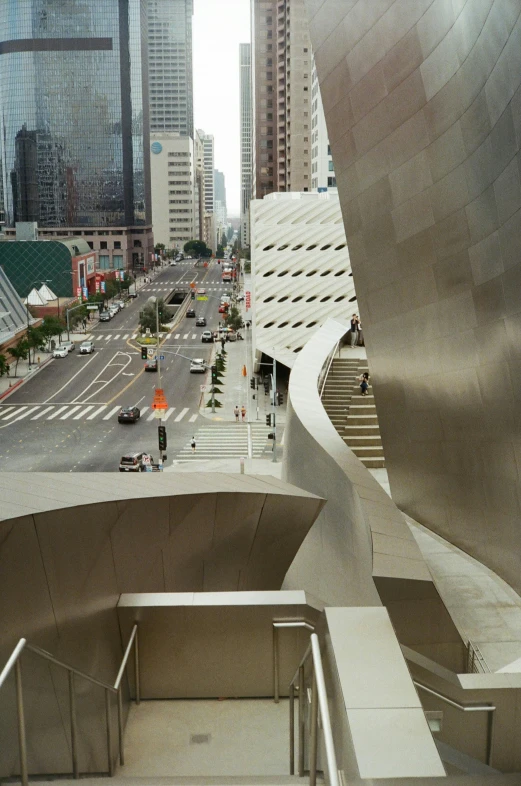 a view of a city from the top of a building, by Ned M. Seidler, unsplash contest winner, modernism, sloped street, morphosis, wide grand staircase, taken in the mid 2000s