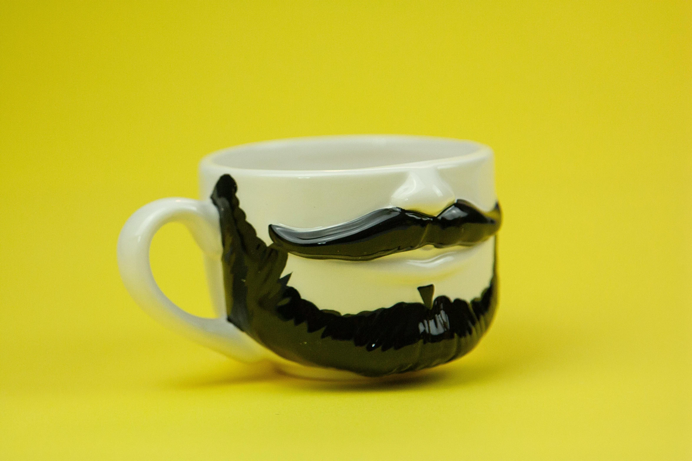 a close up of a coffee cup with a mustache on it, inspired by Muggur, pop art, with a full black beard, ceramics, side front view, modeled