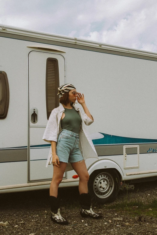 a woman standing in front of a trailer talking on a cell phone, pexels contest winner, renaissance, white and teal metallic accents, instagram picture, summertime, streetwear