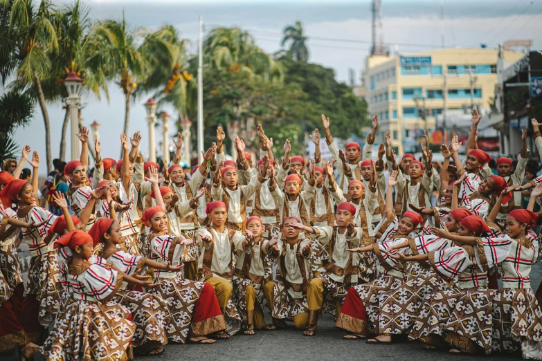 a group of people that are standing in the street, by Ellen Gallagher, pexels contest winner, tribal dance, philippines, corps scattered on the ground, panoramic shot