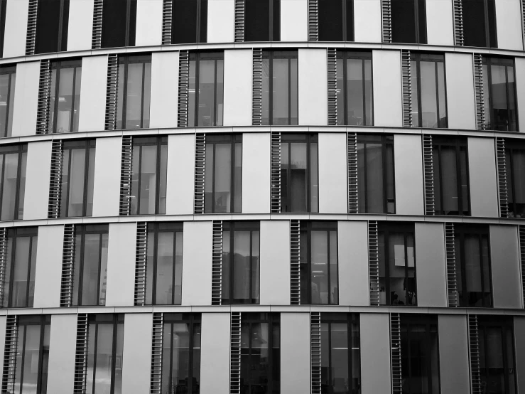 a black and white photo of a building, inspired by David Chipperfield, pexels, fake windows, patterned, berlin, stacked