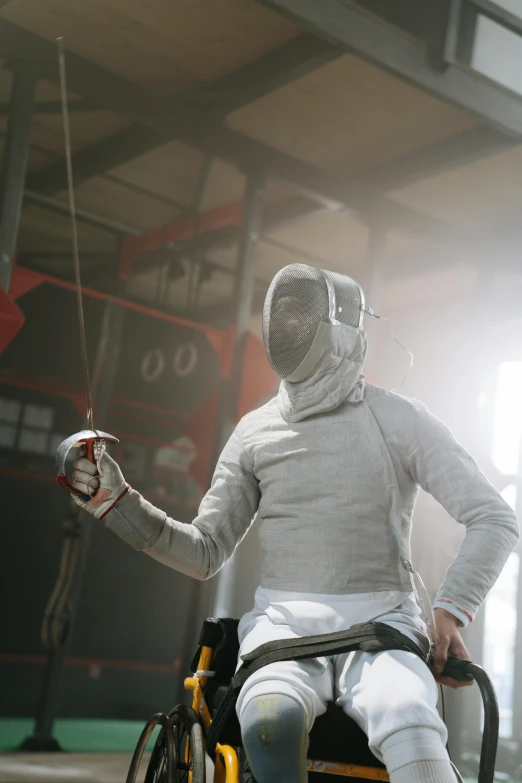 a man in a wheelchair holding a tennis racquet, a portrait, unsplash contest winner, renaissance, fencing, man in silver space suit, working in the forge, white and red body armor