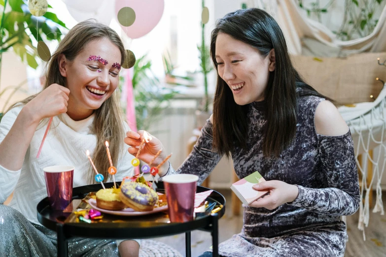 a couple of women sitting next to each other at a table, pexels contest winner, happening, pals have a birthday party, loputyn and matcha, profile image, birthday cake on the ground