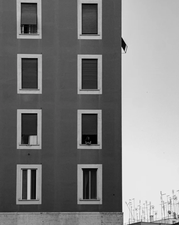 a black and white photo of a tall building, a black and white photo, by Paolo Parente, unsplash, postminimalism, neighborhood outside window, 2 5 6 x 2 5 6, roma, tri - x pan