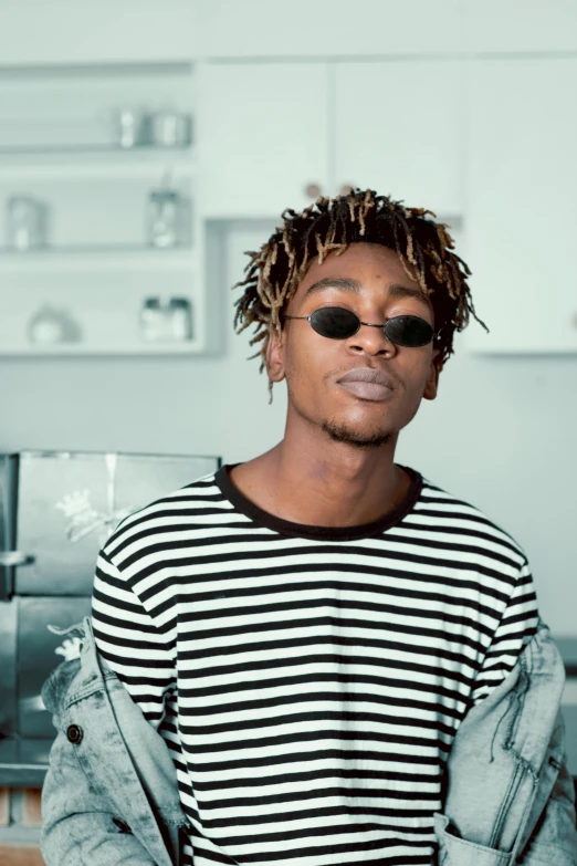 a man wearing sunglasses and a striped shirt, an album cover, inspired by Barthélemy Menn, trending on pexels, neat hair, loosely cropped, in a kitchen, clean background trending