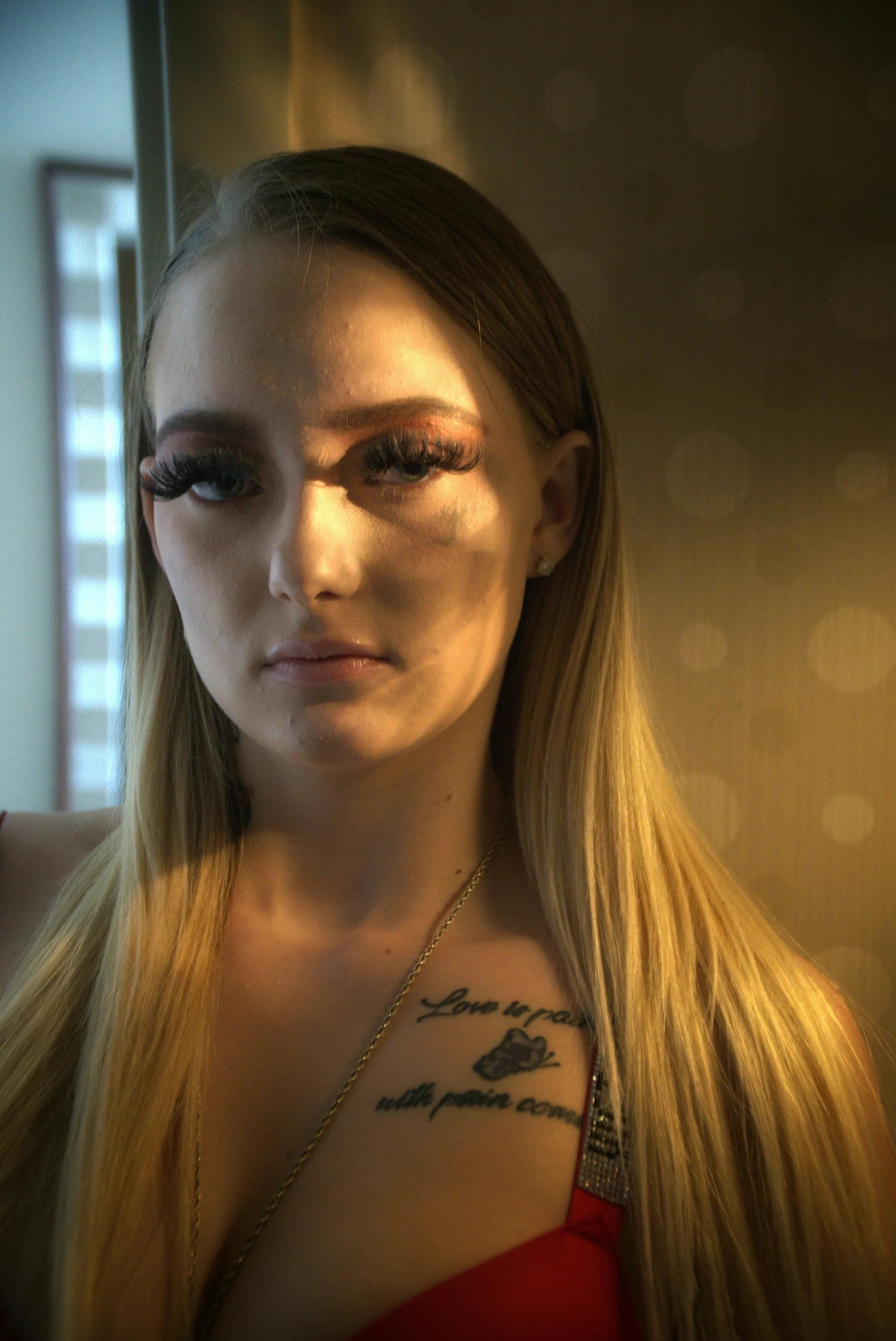 a woman in a red dress posing for a picture, a tattoo, inspired by Nan Goldin, featured on reddit, photorealism, portrait of kim petras, unreal engine : : rave makeup, hotel room, highly detailed vfx portrait of