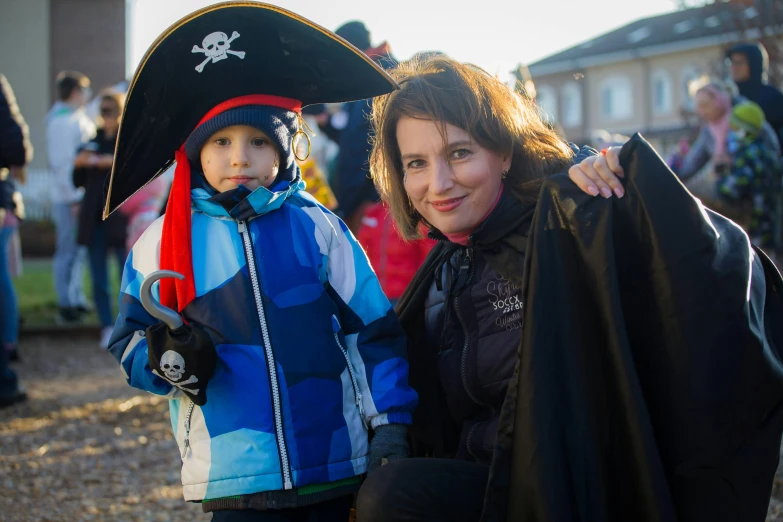 a woman and a child dressed up in pirate costumes, by Ejnar Nielsen, happening, tjalf sparnaay 8 k, count dracula, halloween night, while smiling for a photograph