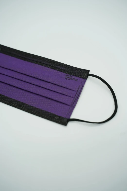 a purple face mask on a white background, inspired by Itō Seiu, sōsaku hanga, purple and black color palate, coated pleats, view from the side, product introduction photo