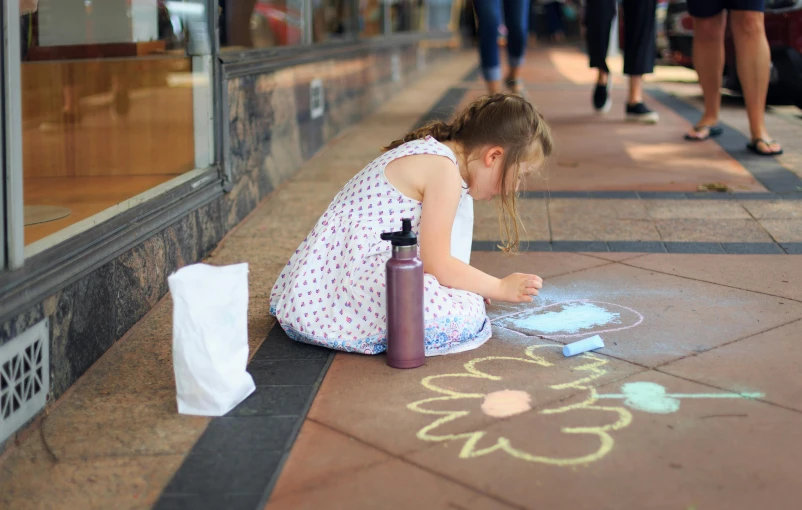 a little girl drawing on the sidewalk with chalk, chalk art, by Tom Bonson, pexels contest winner, street art, intricate oil pastel glow, on a hot australian day, art decos, flowers around