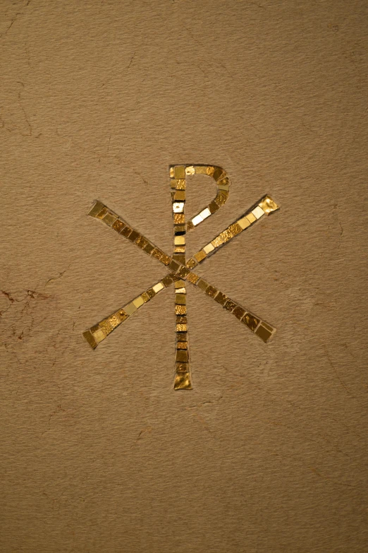 a close up of a gold sticker on a wall, an album cover, inspired by Mariotto Albertinelli, trending on pexels, renaissance, runes, crosses, phonk album cover, embedded with gemstones