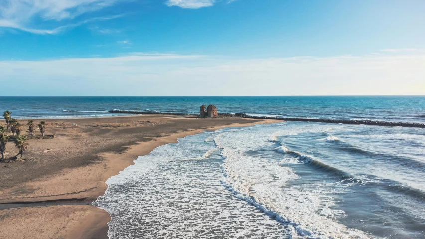 a sandy beach next to the ocean on a sunny day, pexels contest winner, byzantine, coastline, hoyte van hoytema, blue sea