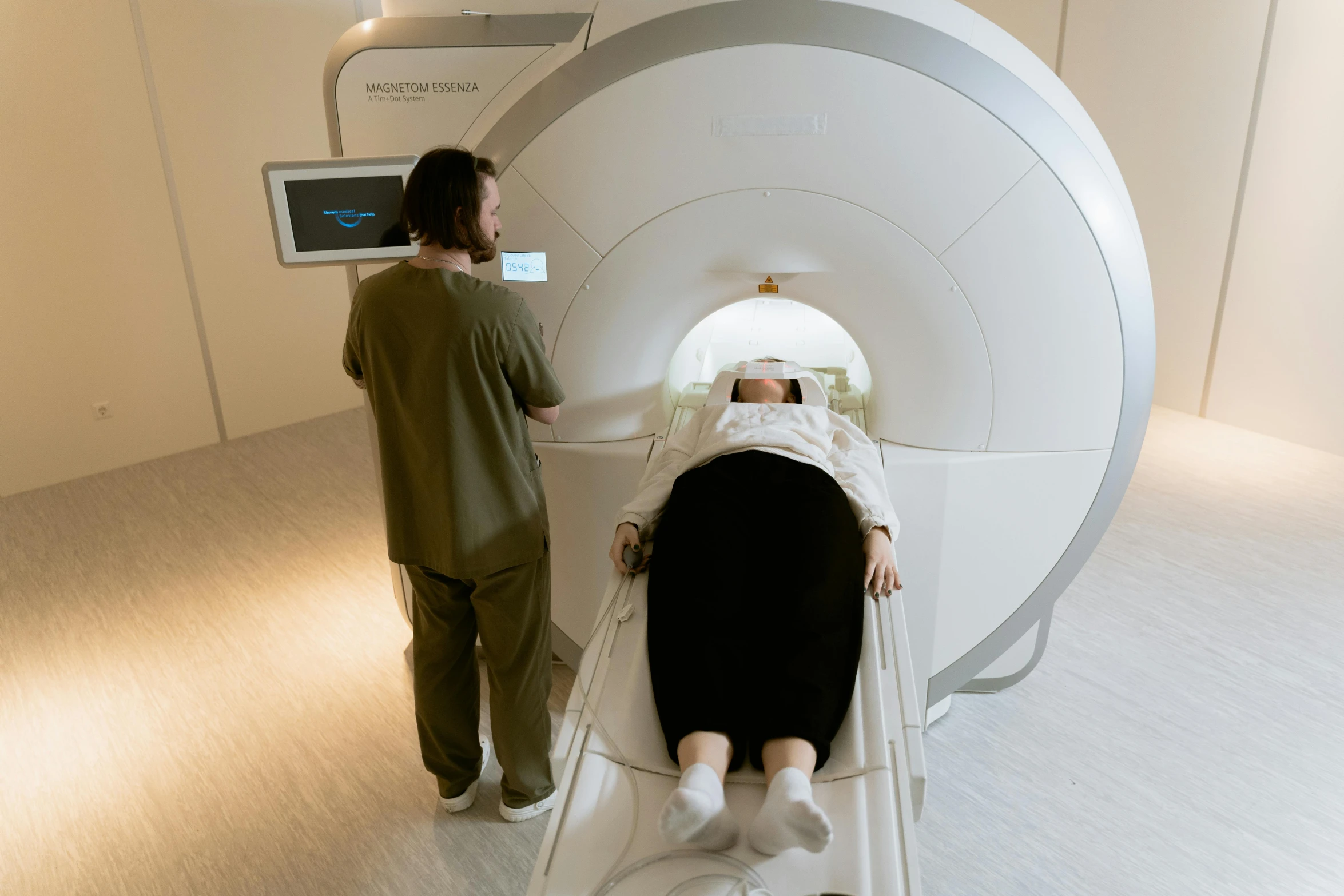 a couple of people that are in a room, a hologram, by Simon Gaon, mri, sydney hanson, medical machinery, woman is curved