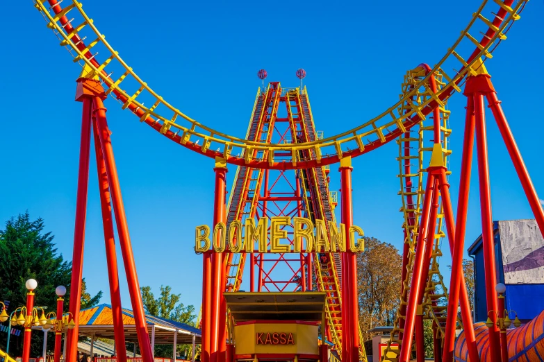 a red and yellow roller coaster at a theme park, a portrait, by Thomas Häfner, shutterstock, fan favorite, oklahoma, golden arches, springtime vibrancy