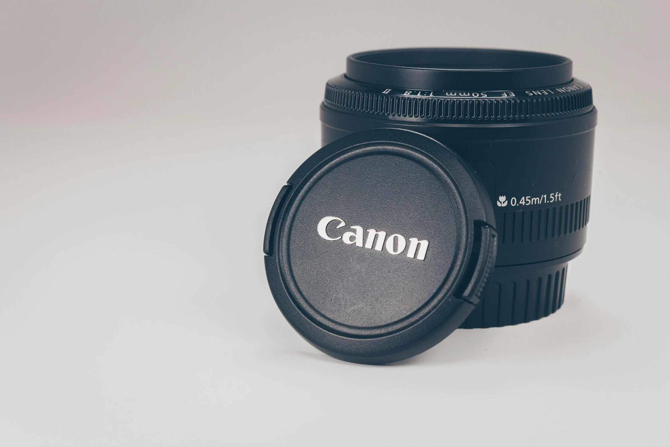 a close up of a camera lens on a table, by Carey Morris, unsplash, photorealism, (canon, textured base ; product photos, canon eos 90d, highly realistic photo